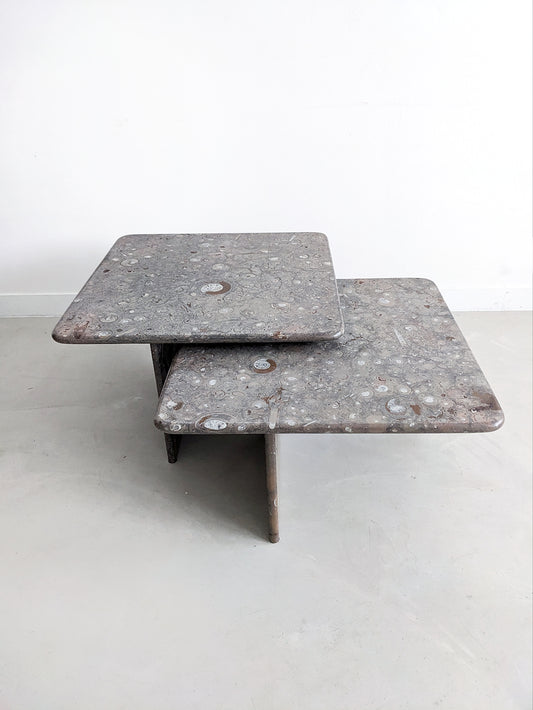 Vintage Design Ammonite fossil Stone nesting tables. Postmodern design from the 1980's. Set of two nesting tables, which slide into each other. Also perfect as coffee table or side table. 